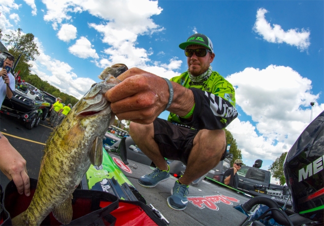 Avena stuffs a Lake Norfork smallie in the bag. Photo by Joel Shangle.