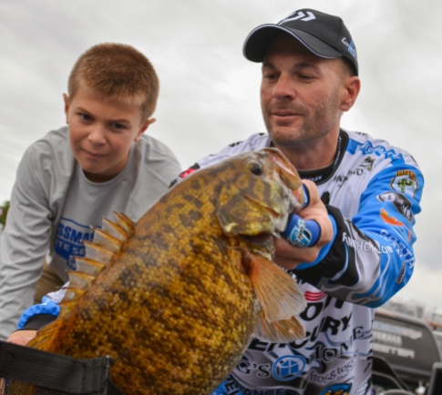 Oakely Howell wonders "How did that fish not eat my dad?" as Livingston pro Randy Howell bags up a giant on Day 3. Photo by Joel Shangle.
